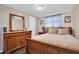 Cozy bedroom featuring a wooden dresser, soft lighting, and a comfortable bed at 3337 Darlington Rd, Holiday, FL 34691