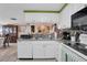 Bright kitchen features white cabinetry, stainless steel appliances, and lots of counter space at 3337 Darlington Rd, Holiday, FL 34691