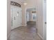 Bright entryway with tile flooring, and view into living room at 390 Royal Palm Way, Spring Hill, FL 34608