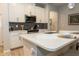 Modern kitchen with white cabinets and hexagon backsplash at 4240 Cloud Hopper Way, Lutz, FL 33559