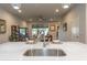 Kitchen island with stainless steel sink and view into living room at 4240 Cloud Hopper Way, Lutz, FL 33559