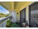 Relaxing balcony featuring chairs, plants, and a storage closet at 455 Alt 19 S # 163, Palm Harbor, FL 34683