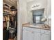Bathroom featuring a vanity, mirror, and a walk-in closet at 455 Alt 19 S # 163, Palm Harbor, FL 34683