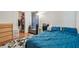 Bright bedroom featuring wood floors, a walk-in closet, and teal bedding at 455 Alt 19 S # 163, Palm Harbor, FL 34683