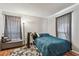 Cozy bedroom with teal bedding, wood floors, and ample closet space at 455 Alt 19 S # 163, Palm Harbor, FL 34683
