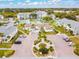 Aerial view of community with pool, tennis courts, and parking at 455 Alt 19 S # 163, Palm Harbor, FL 34683