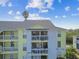Yellow condo building with balconies at 455 Alt 19 S # 163, Palm Harbor, FL 34683