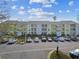 Yellow condo building with parking lot at 455 Alt 19 S # 163, Palm Harbor, FL 34683