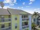Yellow condo building with balconies at 455 Alt 19 S # 163, Palm Harbor, FL 34683