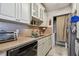 Well-equipped kitchen featuring modern appliances and ample cabinetry at 455 Alt 19 S # 163, Palm Harbor, FL 34683