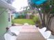 Backyard with a wooden deck and a large table with white chairs, perfect for outdoor dining at 641 Wilkie St, Dunedin, FL 34698