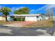 Front view of a single story home with a red brick driveway at 7923 Hawthorn Dr, Port Richey, FL 34668