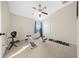 Home gym with weight bench, dumbbells, and ceiling fan at 9621 Southern Charm Cir, Brooksville, FL 34613