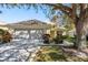Charming single-story home with attached two-car garage, landscaped front yard, and mature shade tree at 14120 Whitecap Ave, Hudson, FL 34667