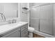 Modern bathroom with gray vanity, white countertop, and a shower stall at 14157 Leybourne Way, Spring Hill, FL 34609
