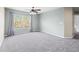 Bright bedroom with ceiling fan, window, and gray carpet at 14157 Leybourne Way, Spring Hill, FL 34609
