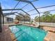 Enclosed pool with slide and patio furniture at 14157 Leybourne Way, Spring Hill, FL 34609