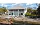 Two-story house with screened porch, backyard patio, and dock at 3207 Hibiscus Dr, Hernando Beach, FL 34607