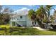 Two-story house with lush landscaping and palm trees at 3207 Hibiscus Dr, Hernando Beach, FL 34607