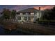 Two-story home with backyard deck overlooking the canal at sunset at 3207 Hibiscus Dr, Hernando Beach, FL 34607