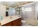 Bathroom with tub, shower, and wood vanity at 3207 Hibiscus Dr, Hernando Beach, FL 34607