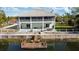 Back exterior showcasing a two-story home with a dock at 3207 Hibiscus Dr, Hernando Beach, FL 34607