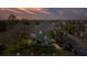 Two-story house with palm trees and a landscaped yard at dusk at 3207 Hibiscus Dr, Hernando Beach, FL 34607