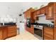 Kitchen features wood cabinets, granite countertops, and stainless steel appliances at 3207 Hibiscus Dr, Hernando Beach, FL 34607