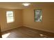 Simple bedroom with light walls and wood-look floors at 3518 Moog Rd, Holiday, FL 34691