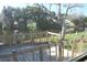 Wooden deck with solar lights overlooking a calm canal at 3518 Moog Rd, Holiday, FL 34691