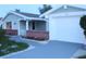 White garage door and walkway leading to the entrance of the house at 3518 Moog Rd, Holiday, FL 34691