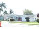 Ranch-style home with attached garage and landscaped lawn at 3518 Moog Rd, Holiday, FL 34691