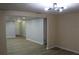 Clean hallway with light gray walls and wood-look flooring at 3518 Moog Rd, Holiday, FL 34691
