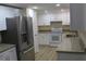 Modern kitchen featuring stainless steel appliances and granite countertops at 3518 Moog Rd, Holiday, FL 34691