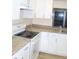 Modern kitchen with granite countertops and white cabinets at 3518 Moog Rd, Holiday, FL 34691