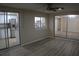 Bright living room with sliding glass doors and wood-look flooring at 3518 Moog Rd, Holiday, FL 34691