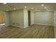 Spacious living room with light walls and wood-look floors at 3518 Moog Rd, Holiday, FL 34691