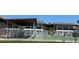 Community pool area with shuffleboard and covered seating at 4829 Onyx Ln # 102, New Port Richey, FL 34652