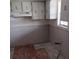 Kitchen showing new drywall and a retro cabinetry providing ample storage ready for renovation and updating at 4829 Onyx Ln # 102, New Port Richey, FL 34652