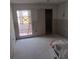 Living room with a sliding glass door to backyard getting renovations with new drywall for a modern touch at 4829 Onyx Ln # 102, New Port Richey, FL 34652
