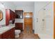 Bathroom featuring vanity, toilet, and shower with wood accent wall in hallway at 6051 Valley Spring Dr, Brooksville, FL 34601