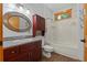 Bathroom featuring a vanity, an oval mirror, a shower and tub combo, and natural wood trim at 6051 Valley Spring Dr, Brooksville, FL 34601