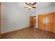 Bright bedroom featuring neutral paint, brick floors, a ceiling fan, and natural wood trim at 6051 Valley Spring Dr, Brooksville, FL 34601