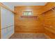 Walk-in closet with wooden shelving and window providing natural light and ventilation at 6051 Valley Spring Dr, Brooksville, FL 34601