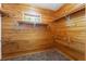 Walk-in closet with wooden shelving and window providing natural light and ventilation at 6051 Valley Spring Dr, Brooksville, FL 34601