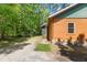 Log cabin home exterior with lush green lawn and landscaped walkway at 6051 Valley Spring Dr, Brooksville, FL 34601