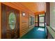 Log cabin front porch with a decorative door and screen door access at 6051 Valley Spring Dr, Brooksville, FL 34601