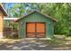 Green paneled garage featuring custom carriage doors at 6051 Valley Spring Dr, Brooksville, FL 34601
