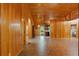 Spacious living room with wood paneling, brick-patterned flooring, and ample natural light at 6051 Valley Spring Dr, Brooksville, FL 34601