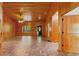 Bright living room showcasing wood paneling, brick-patterned flooring, and many doors at 6051 Valley Spring Dr, Brooksville, FL 34601